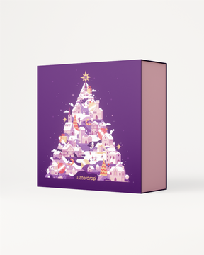 Advent Calendar Large featuring a Christmas tree design on a purple box. Contains limited edition accessories, drinkware, and bestselling flavors, perfect for festive storage.